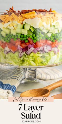 a layered salad in a glass dish with the title text overlay reads 7 layer salad