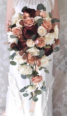 a bride holding a bouquet of flowers in her hands