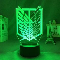 a green illuminated lamp with the symbol of attack squadron on it in front of a eiffel tower