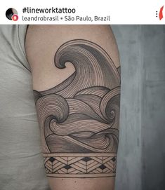 a man's arm with a wave tattoo on it