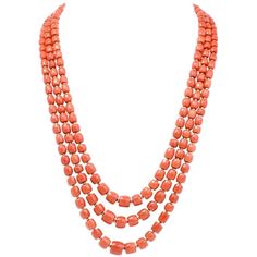 This elegant Vintage necklace incorporates three strands of graduated barrel-shaped natural red color coral beads measuring from 11mm to mm in diameter. The coral beads are silk-strung and inserted throughout the three strands by enchanting 18K yellow gold beads of identical barrel shape. This authentic vintage necklace secures with a finely textured orbicular yellow gold clasp and remains in excellent condition. Weight: 128.7 grams Measurements: Coral strands 22.5 , 24 and 27 inches long Coral Coral Necklaces, Gold Beads Necklace, Beading Necklaces, Necklaces Red, Necklaces Beaded, Amber Bead Necklace, Necklaces Vintage, Red Coral Necklace, Coral Beads Necklace