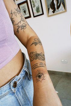 a woman's arm with tattoos on it