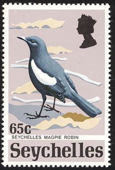 a postage stamp with a bird on it's side and a man in the background