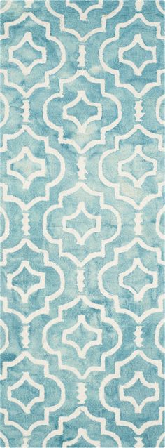 a blue and white rug with an abstract design on the bottom, it is very soft