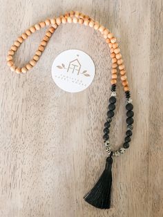 Boho style beaded necklace with large tassel in black Black 8mm Beads Beach Jewelry, Black Beach Jewelry With 8mm Beads, Black Beaded Jewelry For Beach, 8mm Beads, Black Spiritual Necklace For Beach, Hand-strung Black Bohemian Beads, Black Hand-strung Bohemian Beads, Black Tassel Necklace With Adjustable Fit, Black Bohemian Beads For Meditation, Bohemian Black Beads For Meditation