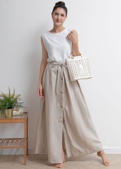 Beige Long Skirt With Buttons, Beige Buttoned Long Skirt, Beige Linen Bottoms With Buttons, Relaxed Linen Skirt With Button Closure, Summer Linen Skirt With Button Closure, Cotton Beach Skirt With Buttons, Beach Cotton Skirt With Buttons, Spring Linen Skirt With Buttons, Casual Linen Skirt With Button Closure