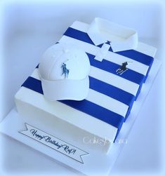 a birthday cake that looks like a polo shirt and hat on top of a box