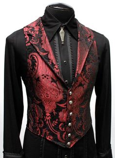 "A Victorian gentleman's vest with class. Great for formal occasions, can be worn under a suit jacket or by itself. Made in red and black tapestry fabric with black satin lining and back. This vest has a very flattering tapered fit and ties in back with satin beltings it can be made tighter in the waist. Fastens in front with six brass buttons. A notched collar adds extra style. Comes in sizes small-3X. (pictured with the empire tux shirt - sold separately) fabulous! Size small = chest 39\" wais Formal Red Vest For Fall, Elegant Fitted Red Vest, Fitted Gothic Vest For Winter, Fitted Red Winter Vest, Fitted Red Vest For Winter, Red Fitted Sleeveless Vest, Aristocrat Vest, Red Vest Outfit, Royal Costumes