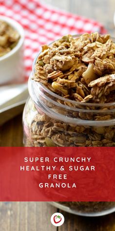 a glass jar filled with granola sitting on top of a table