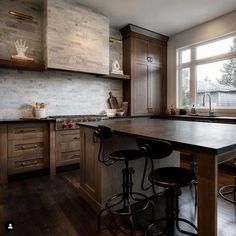 a kitchen with two stools and an island