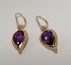 "Thanks for shopping our vintage estate store. We tend to sell well below wholesale and truly hope you enjoy all of our items. Many of the items are one of a kind, so please enjoy scrolling through the pictures and hopefully something will catch your eye. Spots are from camera or reflections. Beautiful estate 14k yellow gold natural 8ct purple amethyst emerald cushion cut tear drop dangle vintage lever back earrings. Gem testing natural and should be natural, 4ct or more per earring. Length: 1.5\" Gem: 11mm by 7mm Width: 3/4\" Weight: 3.92 grams Marked 14k and testing to be 14k, stunning, some that you will love." Classic Pear-shaped Purple Jewelry, Classic Purple Pear-shaped Jewelry, Unique Amethyst Teardrop Earrings, Yellow Gold Amethyst Teardrop Pendant Jewelry, Yellow Gold Amethyst Teardrop Earrings, Teardrop Faceted Amethyst Jewelry, Teardrop Multi-stone Amethyst Earrings, Beautiful Anklet, Gold Sun