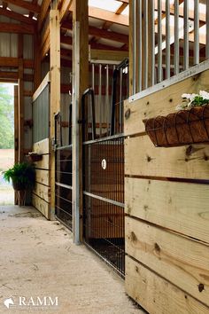 the inside of a horse barn with wooden walls