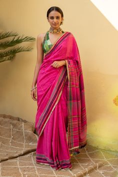 Indian pink saree with stripe, geometric woven motifs on border. Comes with running blouse piece.
Components: 1
Pattern: Woven
Type Of Work: Geometric, stripe
Fabric: Organic Cotton
Color: Pink
Other Details: 
Note: Stitched blouse worn by the model is not for sale
Disclaimer: The joint fabric pieces may vary. Designers unique process ensures that the placement of fabric will always be similar but not same. They always create the product with stretch fabrics of similar types and weights that fit Traditional Drape Blouse With Woven Motifs, Pink Handloom Slub Silk Pre-draped Saree, Pink Handloom Blouse Piece For Navratri, Designer Saree With Traditional Weaving Work, Cotton Silk Saree Blouse With Woven Motifs, Pink Chanderi Saree With Woven Motifs, Pink Handloom Blouse Piece For Transitional Season, Festive Pink Saree With Woven Motifs, Transitional Pink Handloom Blouse Piece