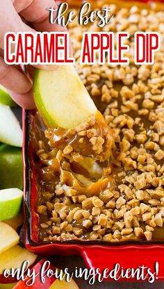 an apple being dipped with caramel on top of oatmeal in a red dish