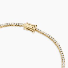 Description This timeless tennis bracelet features a 14k solid gold diamond-studded chain. Its slim, sturdy silhouette is perfect for stacking with other fine jewelry. A tennis bracelet is the perfect gift for a special occasion (or maybe just because). Product Details 1.05 total carat weight 103 total 1.25 mm - 1.3 mm genuine GH SI1- SI3 diamonds 14k solid gold Total length 6.5" Box clasp closure Classic Pave Setting Tennis Bracelet, Classic Diamond Tennis Bracelet With Pave Setting, Classic White Gold Diamond Bracelet With Pave Setting, Luxury Round Cut Tennis Bracelet With Pave Setting, Luxury Tennis Bracelet With Pave Setting, Luxury Diamond Tennis Bracelet With Pave Setting, Fine Jewelry Diamond White Tennis Bracelet With Pave Setting, Classic White Gold Tennis Bracelet With Pave Setting, Luxury White Gold Tennis Bracelet With Pave Setting