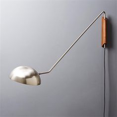 a wall mounted lamp on the side of a gray wall