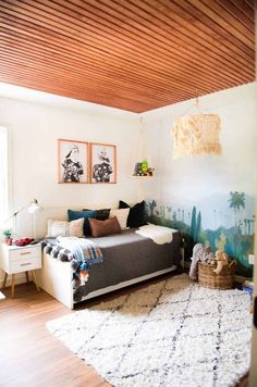 a living room with a couch, rug and pictures on the wall