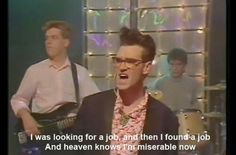 two men singing and playing guitar in front of a tv screen with the caption i was looking for a job, and then i found a