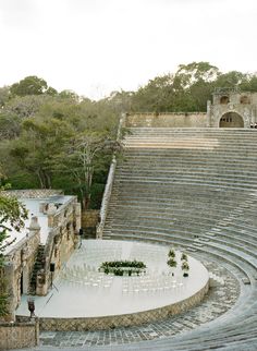 an aerial view of a stone amphit with chairs set up in the middle for a wedding ceremony