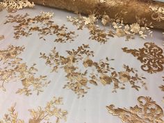 gold and white fabric with flowers on it