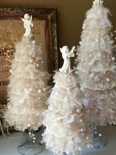 three white christmas trees with pearls on them