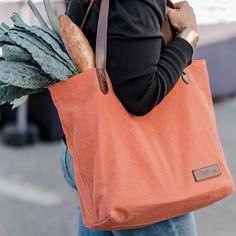 Color: Rust Canvas With Dark Brown Leather Handles Wine Country's "It Bag", The Farmers Market Wine Tote Is A Casual, Every Day Tote Crafted Of Cotton Canvas And Leather. This Fresh, Easy Bag Is A Stylish Staple That Will Add A Splash Of Color To Your Day. The Interior Is Conveniently Designed With Two Bottle Pockets So You Can Keep Your Water Bottle And Wine Bottle Handy. A Zippered Interior Pocket And Cell Phone Pouch Keep You Organized. And If You Forget To Bring Your Grocery Bag To The Marke Easy Bag, Cell Phone Pouch, It Bag, Selling Design, Wine Tote, Model Inspo, Market Tote, Phone Pouch, Simple Bags