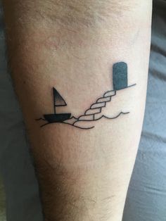 a man's arm with a small boat on it