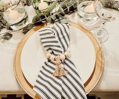 a white plate topped with a black and white striped napkin on top of a table