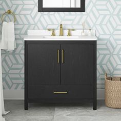 a bathroom vanity with a mirror, sink and towel rack in front of a geometric wallpaper