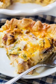 a slice of quiche on a white plate with a blue checkered table cloth