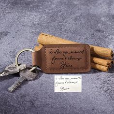 a leather keychain with some cinnamon sticks on it and a note attached to it