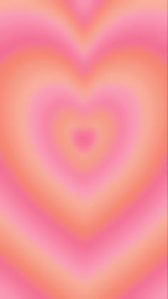 an abstract pink and orange background with a heart shape in the center, as if it were blurred or blurry