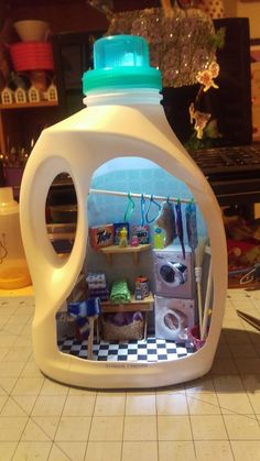 a white plastic container filled with lots of items on top of a tiled floor next to a counter