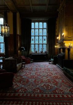 a large room with many windows and couches in front of the window is lit by candles