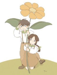 two children are standing next to each other with a flower in the middle of them