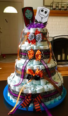 a diaper tree made to look like it is decorated with halloween decorations and ribbons