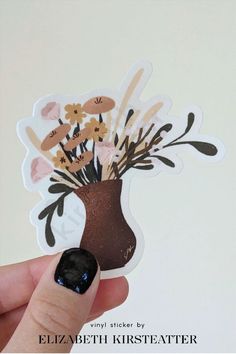 a hand holding up a sticker with flowers in a vase on the top and bottom