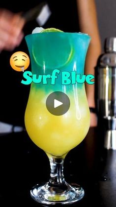 a yellow and blue drink sitting on top of a table