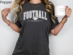 Elevate your game day style with this Comfort Colors® Football Mama t-shirt, a must-have for any football mom. It's the perfect addition to your game day wardrobe, so get ready to cheer on your favorite football team in style! Printed on Comfort Colors 1717 pre-shrunk, 100% cotton t-shirts that are known for their softness, durability and relaxed fit. They are made with a unique pigment-dyed process that gives them a vintage, lived-in look right from the start. The seams are double-needle stitch Football Season Tops With Team Logo For Sports Fans, Sports Fan Tops With Team Logo For Football Season, Game Day Team Spirit T-shirt With Relaxed Fit, Football Season Fan Apparel T-shirt With Name Print, Collegiate Relaxed Fit Tops For Football Season, Game Day Sports Fan Tops For Football Season, Sports Fan Tops For Football Season Game Day, Relaxed Fit Sports Fan T-shirt, Sports Fan Tops For Game Day During Football Season