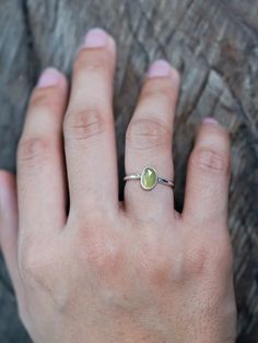 The rose cut peridot (August birthstone) shines alongside a tiny round green sapphire (September birthstone), both held securely in a bezel setting. Pair your peridot ring with peridot earrings to channel a free spirited and joyful vibe. Let this ring be the statement piece that adds a touch of whimsy and elegance to your style. Each piece of our jewelry is handcrafted with love. Lime Green Sterling Silver Birthstone Rings, Lime Green Sterling Silver Rings As Gift, Lime Green Sterling Silver Rings For Gift, Green Peridot Stackable Promise Rings, Green Gemstone Sterling Silver Birthstone Ring, Peridot Ring Jewelry, Lime Green Peridot Promise Ring, Lime Green Peridot Ring, Green Sapphire Sterling Silver Ring For May Birthstone