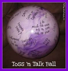 a purple and white balloon with writing on it that says toss'n talk ball