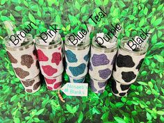 four different colored leopard print tumblers with the words don't tell out next to them