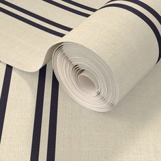 a roll of white and black striped wallpaper