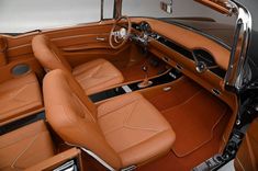 the interior of an old fashioned car with leather seats