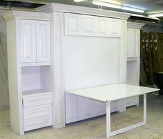 a white table and cabinets in a room with no one on it or someone else