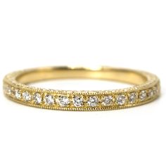 a yellow gold wedding band with diamonds