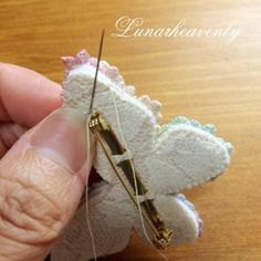 someone is stitching something with a pair of scissors