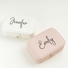 two small pink and white boxes with writing on the front one has a name tag