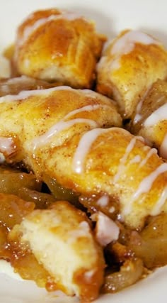 a white plate topped with cinnamon rolls covered in icing and caramel glaze