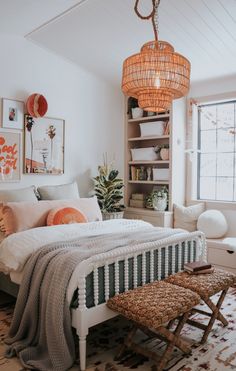 a bed room with a neatly made bed and a wicker basket hanging from the ceiling